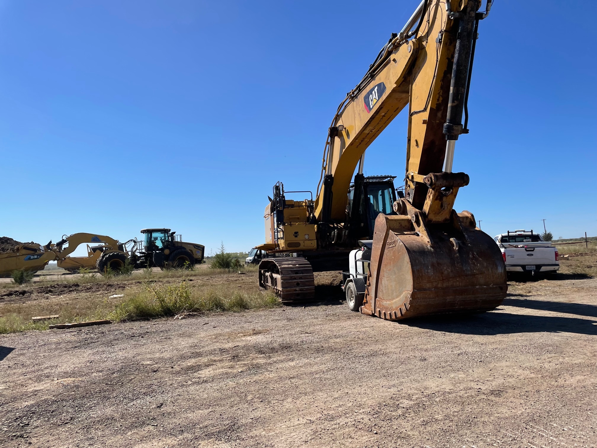 An excavator breaks ground at the site of the new Panasonic EV battery facility in De Soto, Kansas.