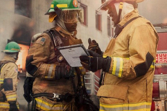 Two firemen holding a Panasonic TOUGHBOOK tablet