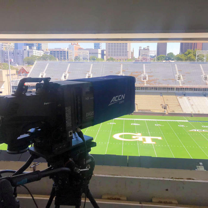 professional broadcasting camera capturing a college football game