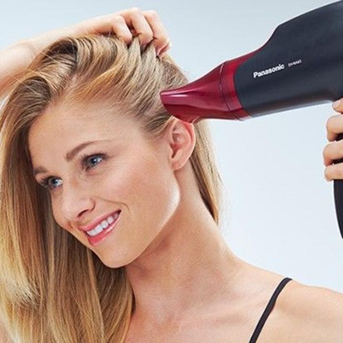 woman using panasonic hairdryer