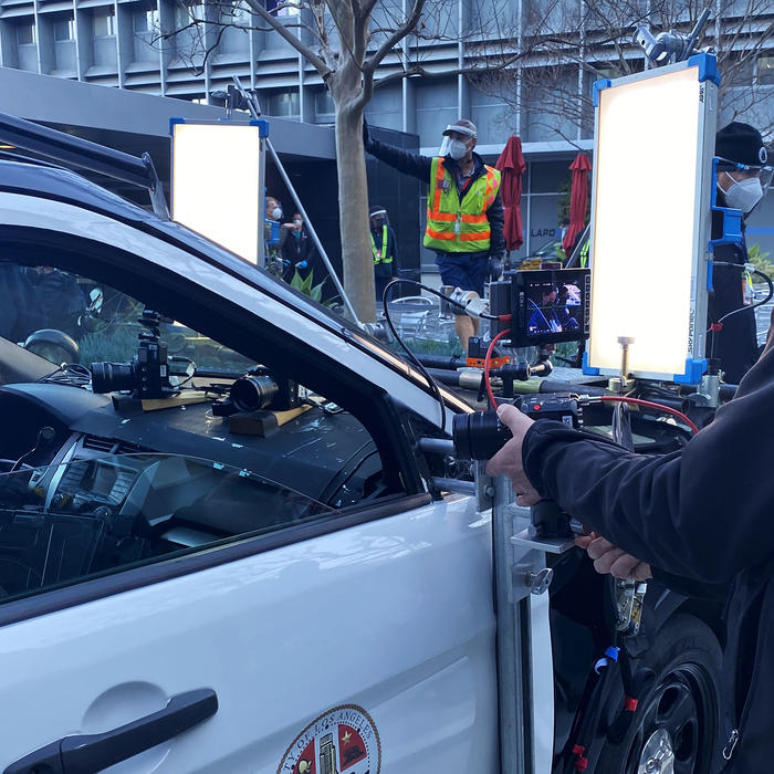 Crewmember sets up a BGH1 on a camera tray on a police car