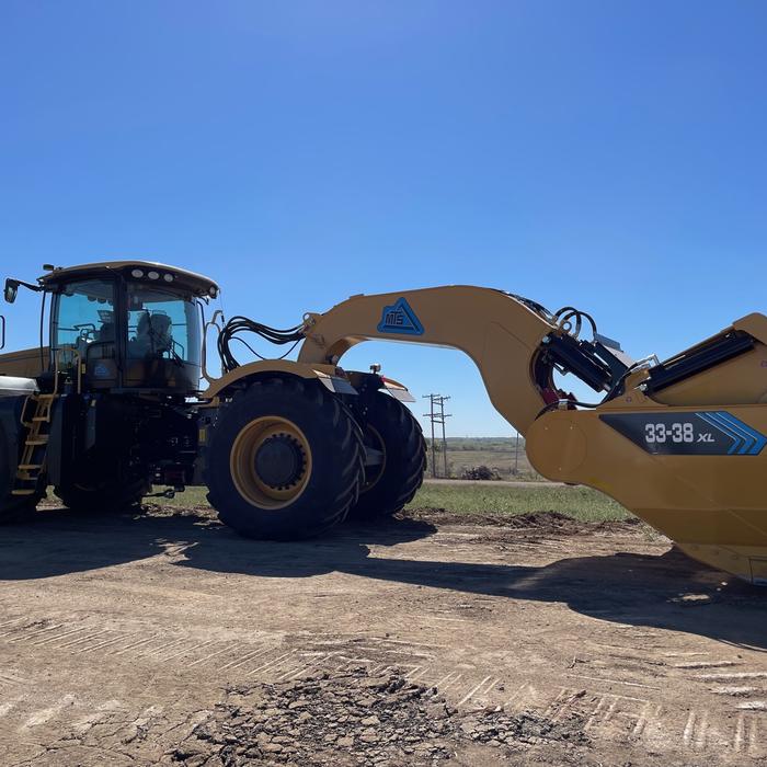 An excavator breaks ground at the site of the new EV battery facility in De Soto, Kansas
